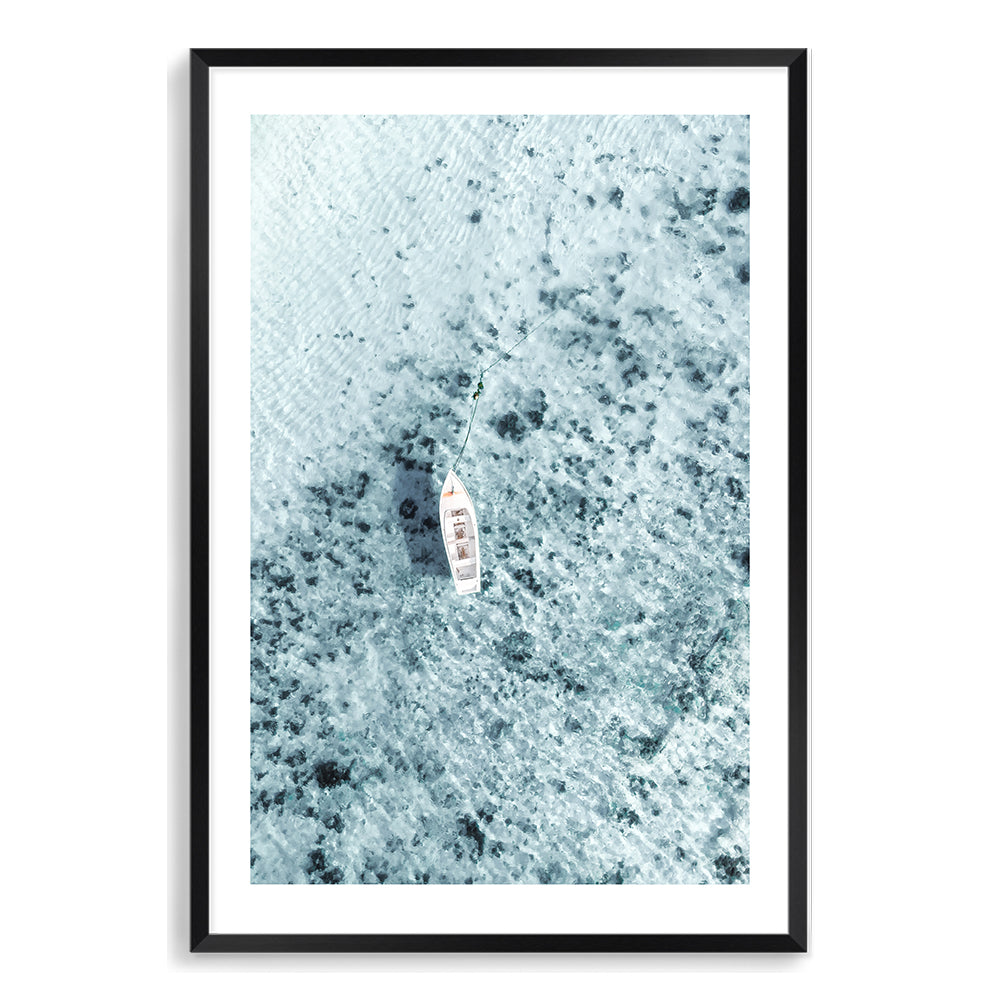 Taken off the Italian Amalfi Coast, this coastal wall art print featuring a white boat on the clear blue ocean waters is available framed on unframed.