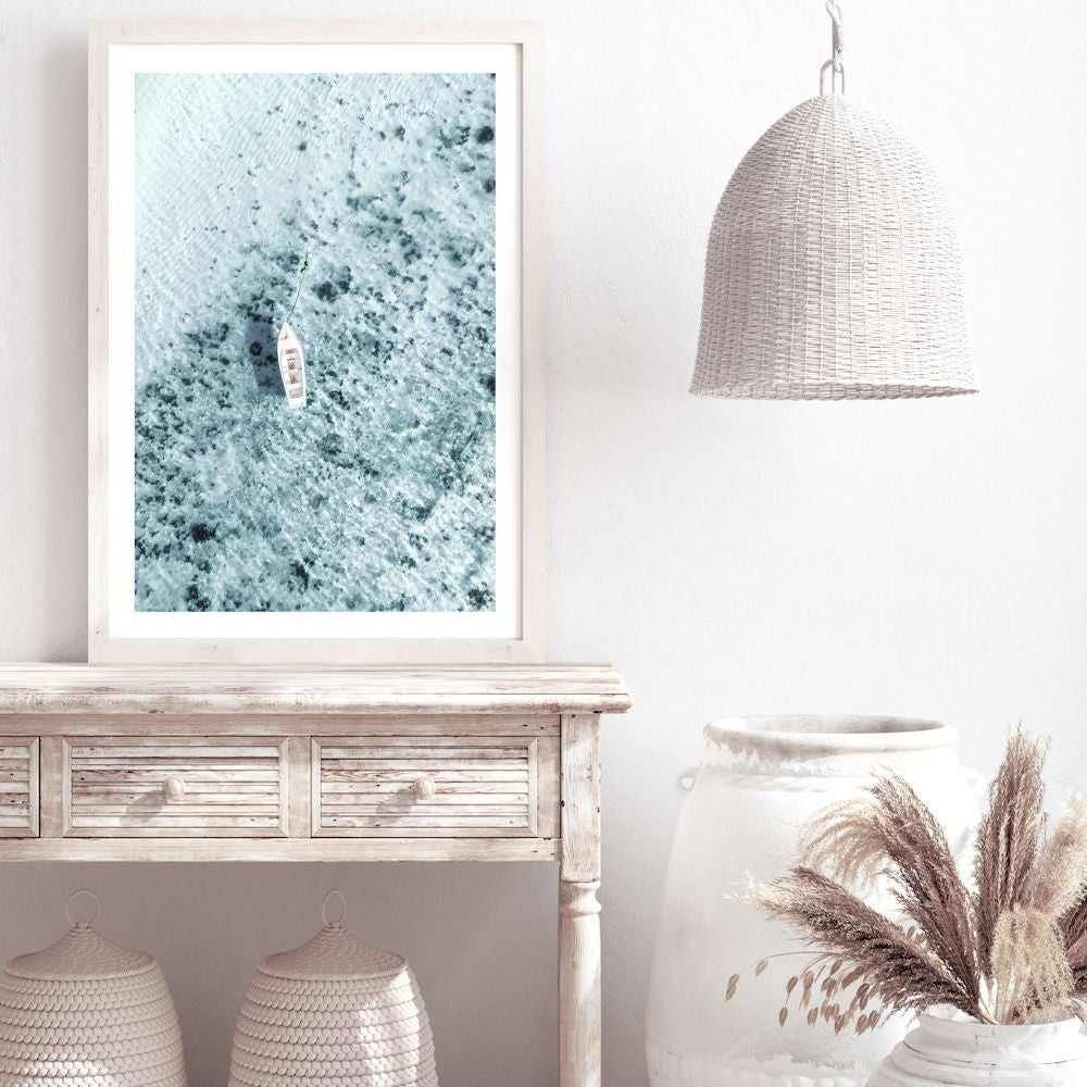 This coastal wall art print, taken off the Amalfi Coast in Italy features a white boat on the clear blue ocean waters.