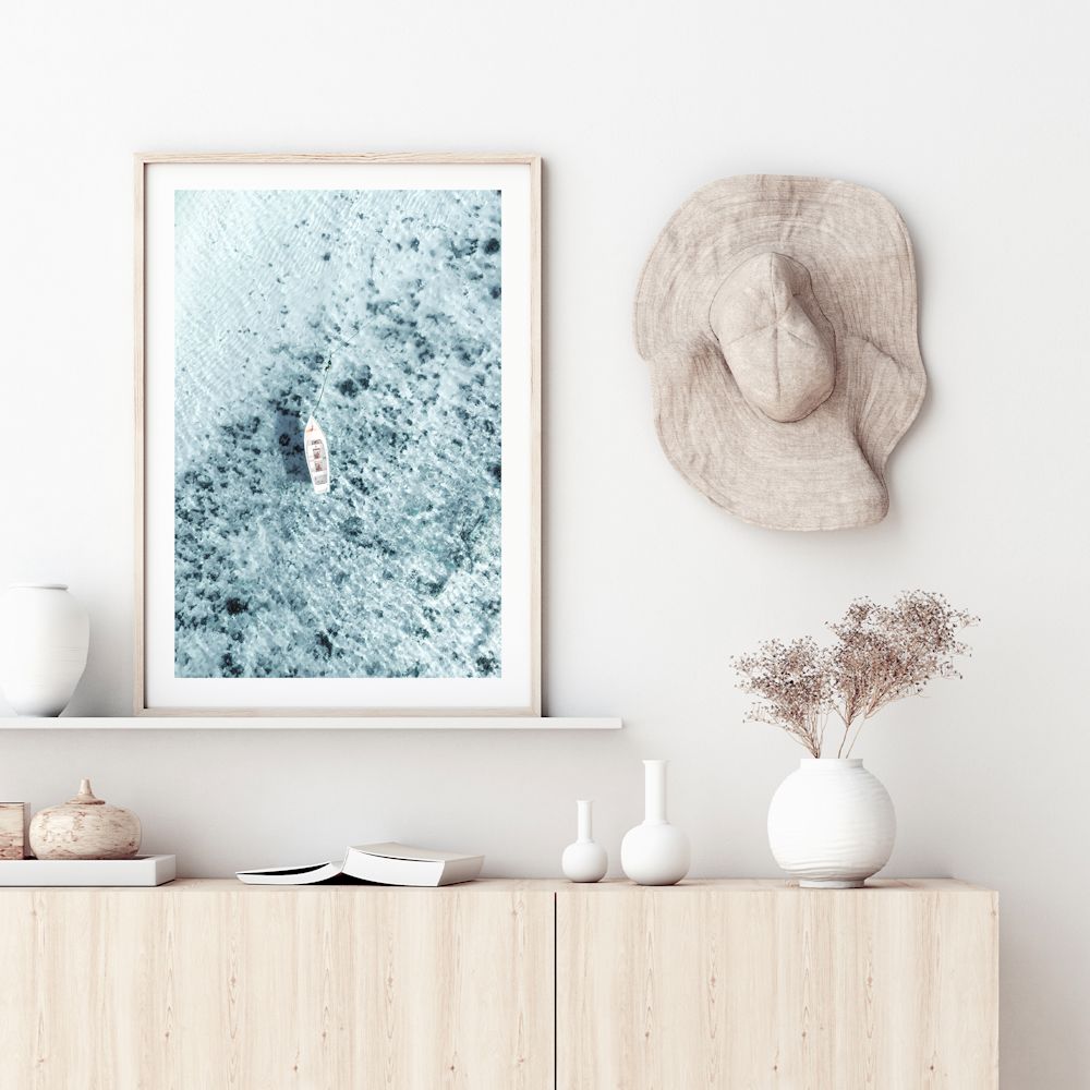 This stretched canvas coastal wall art print, taken off the Amalfi Coast in Italy features a white boat on the clear blue ocean waters.