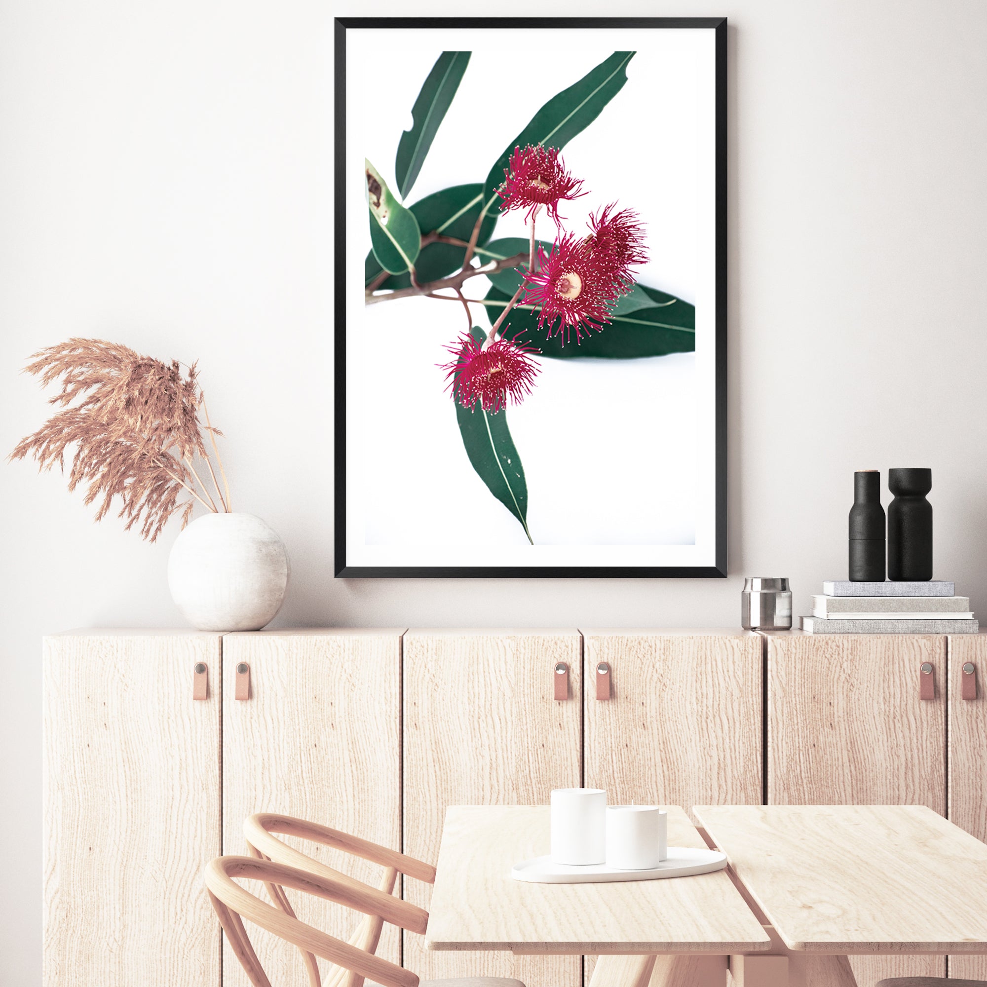 This floral art print features green eucalyptus leaves highlighting beautiful red wild flowers, available with a timber, black or white frame.