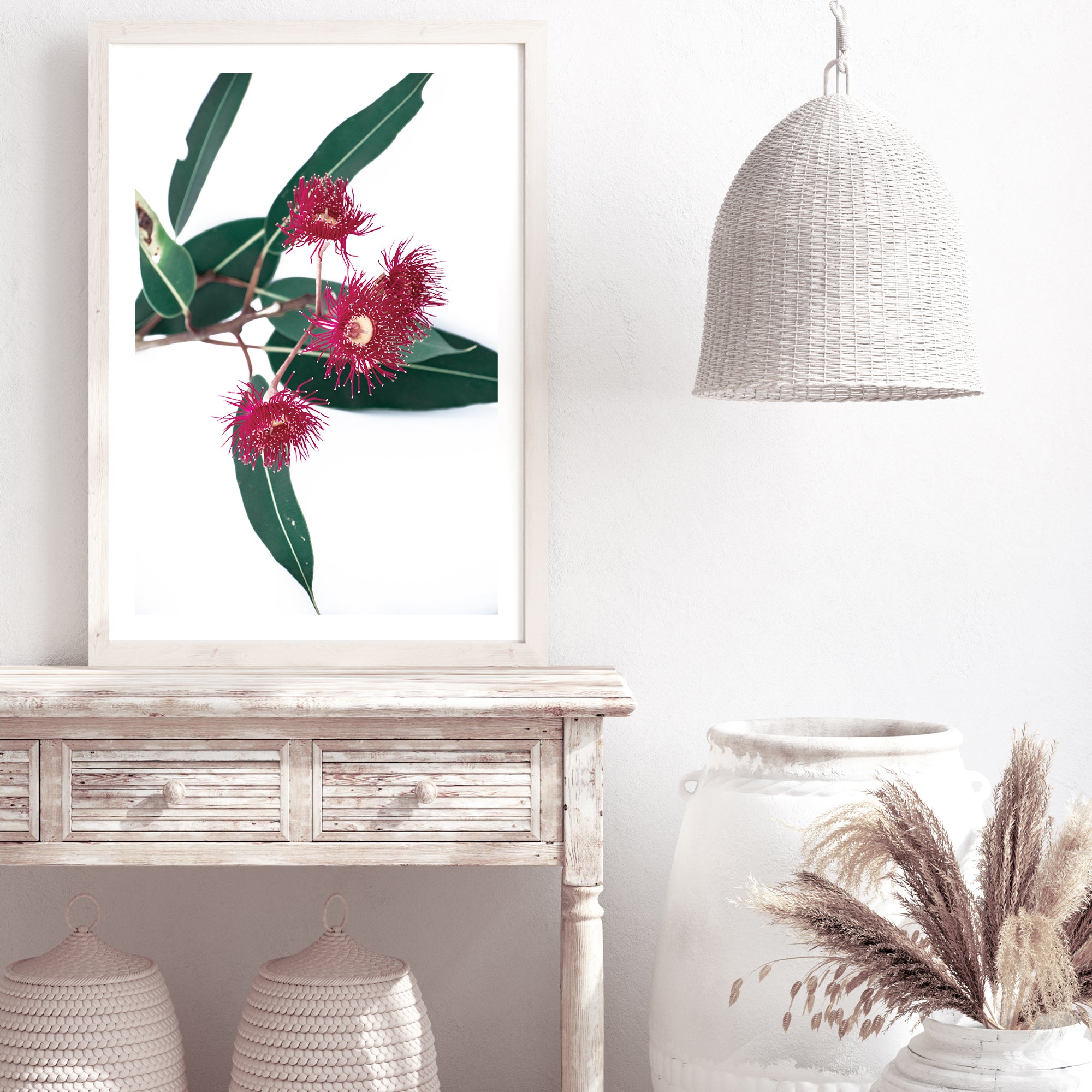 A beautiful floral artwork of green eucalyptus leaves and red wild flowers, available framed or unframed.