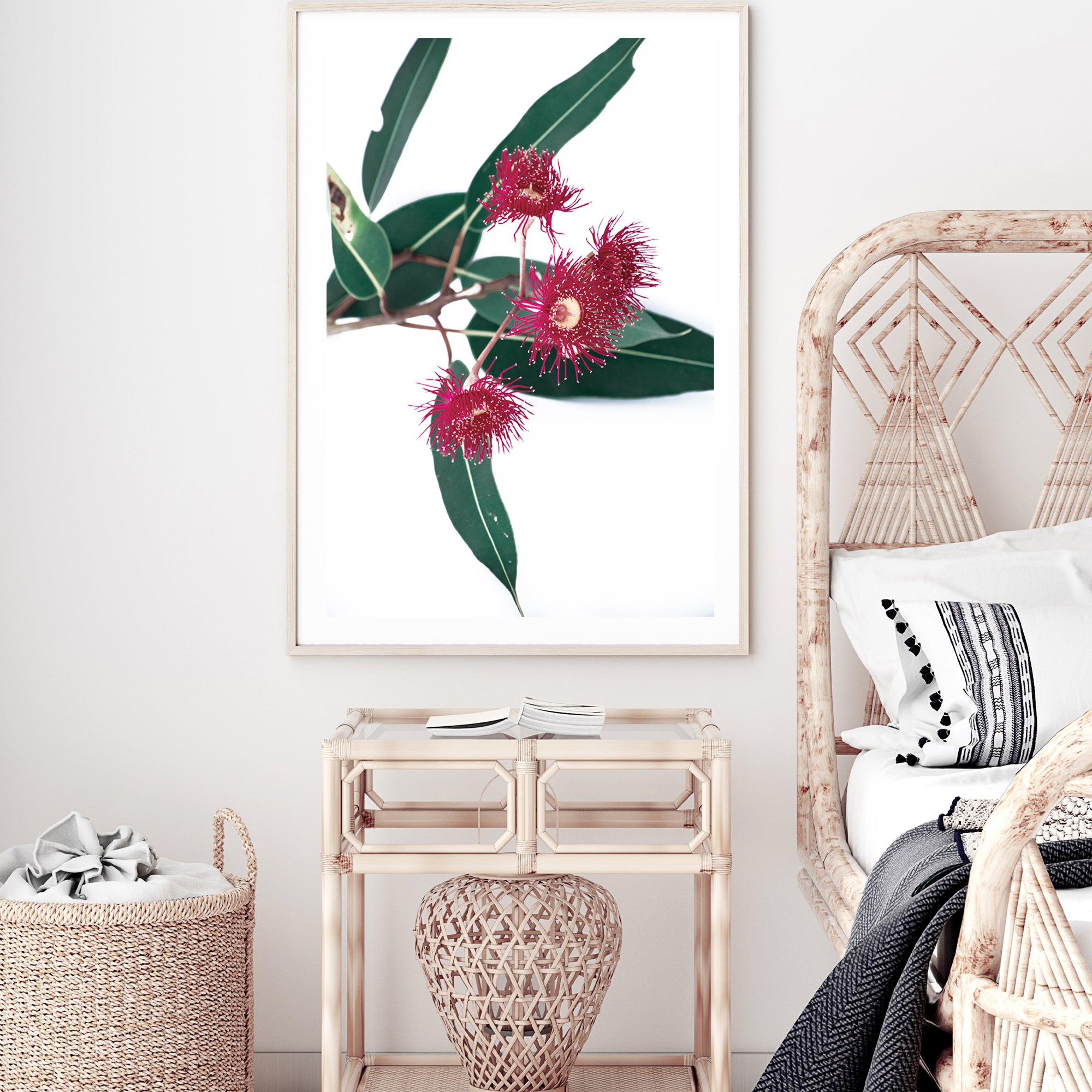 A floral photographic artwork featuring green eucalyptus leaves and beautiful red wild flowers, available framed or unframed.