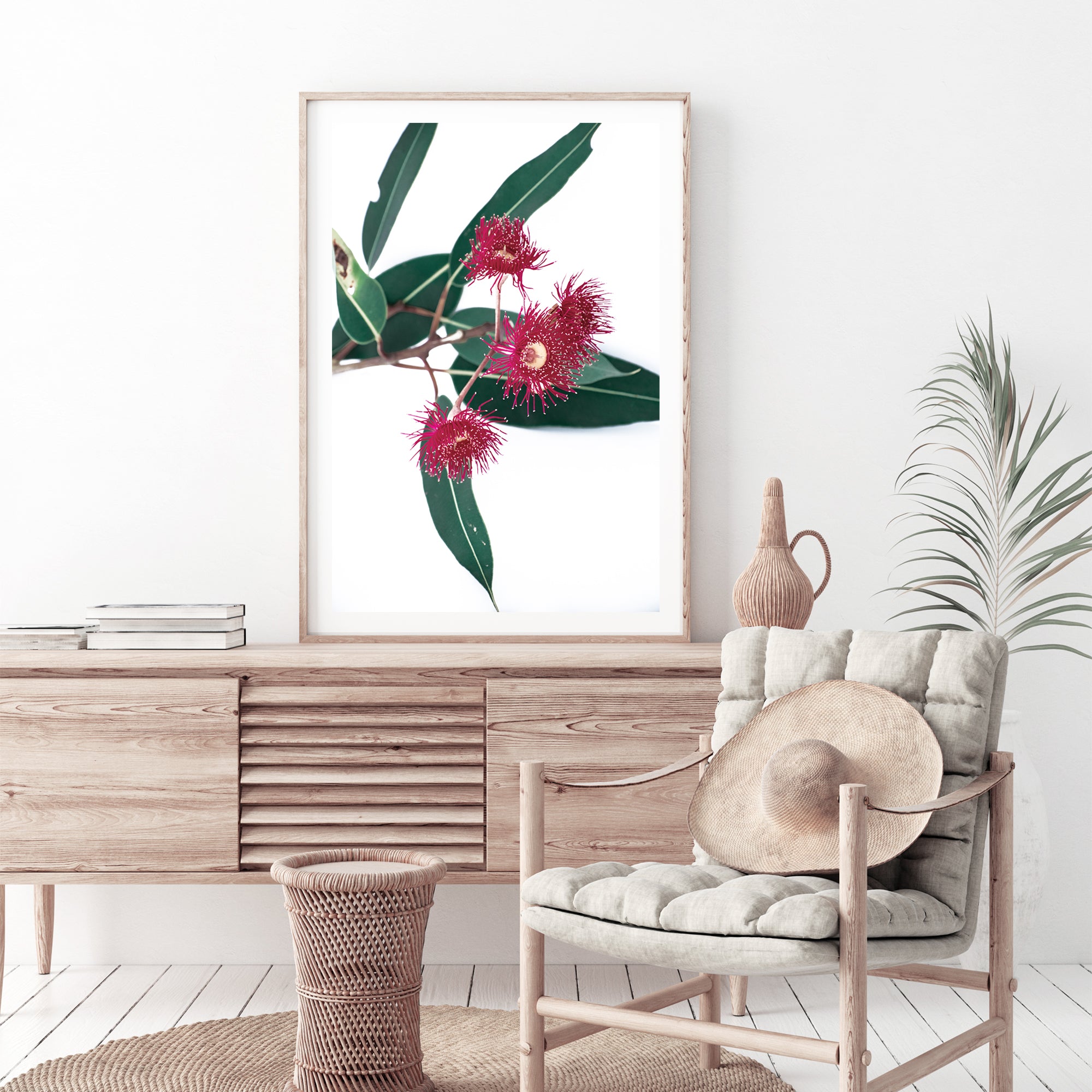 A beautiful floral wall art featuring green eucalyptus leaves and red wild flowers, available in canvas and art prints.