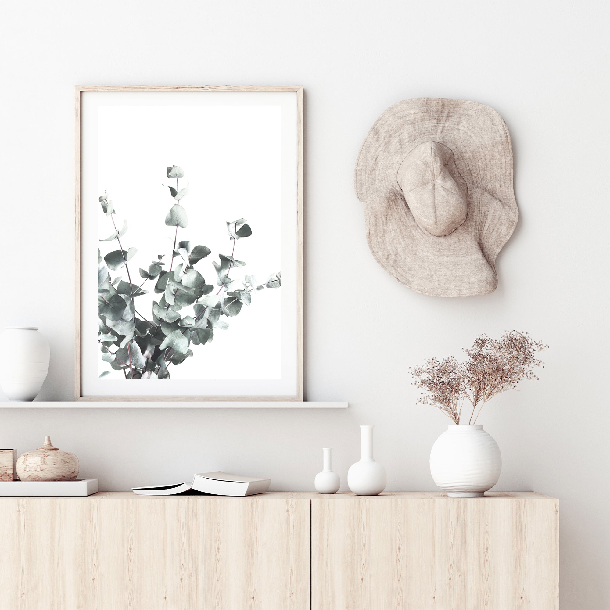 A framed or unframed artwork of eucalyptus leaves (A)with a neutral background available as a canvas or photo print.