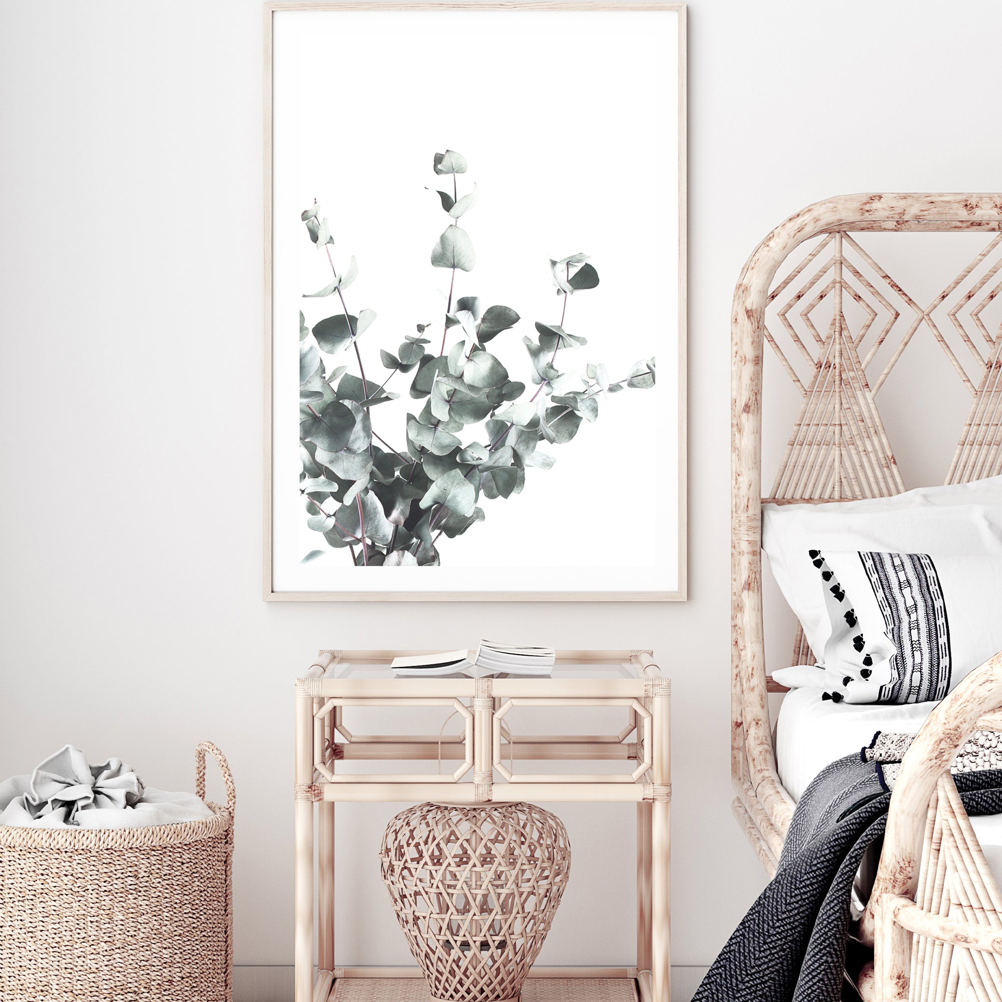 A framed or unframed wall art print featuring eucalyptus leaves (A)with a light background available as a canvas or photo print.