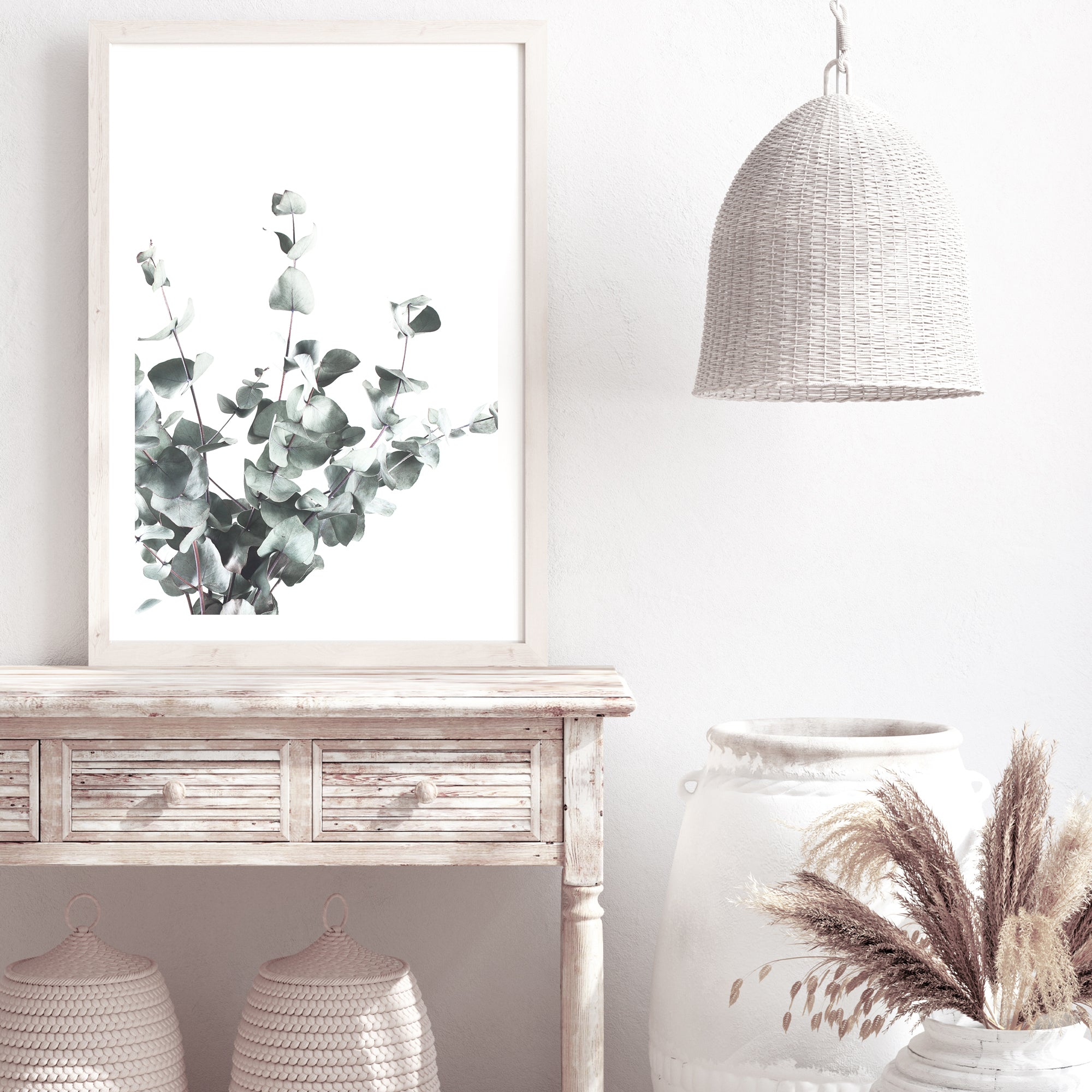 A framed or unframed artwork feauturing eucalyptus leaves (A)with a light background available as a canvas or photo print.