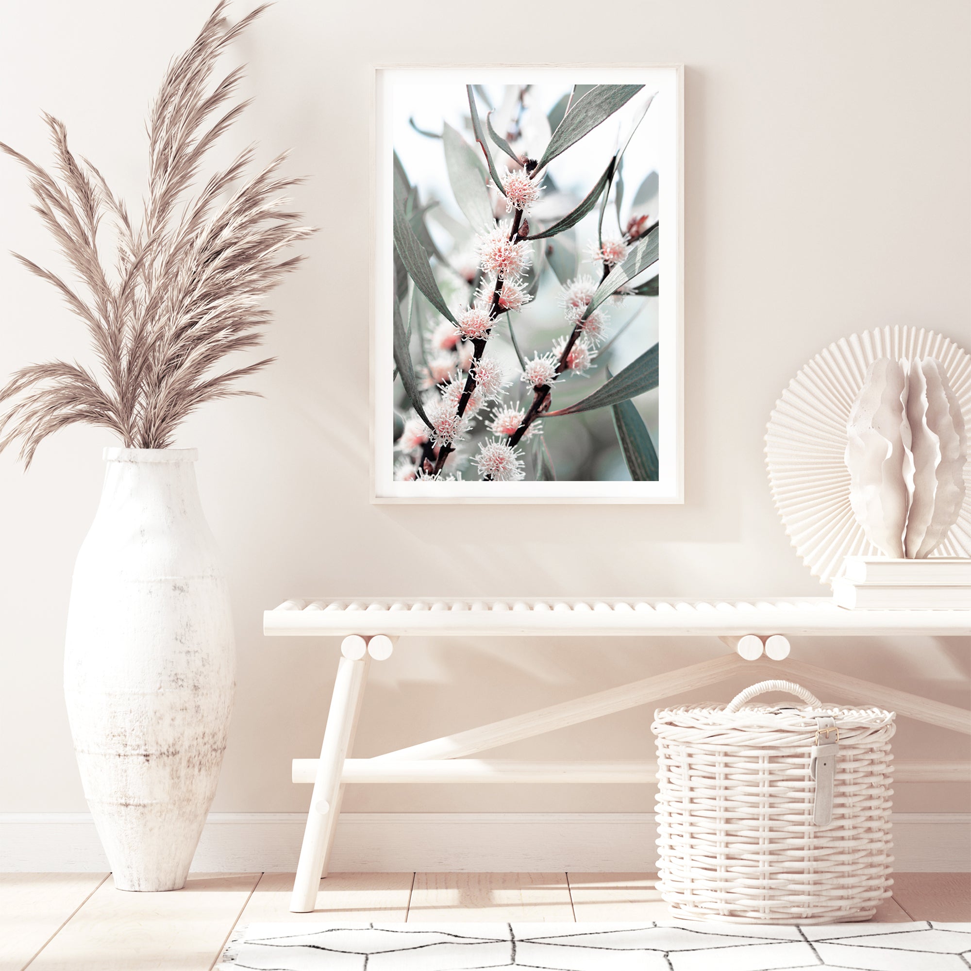 A framed or unframed wall art print of eucalytpus pink wild flowers and green leaves with branches in the background on canvas or photo print.  