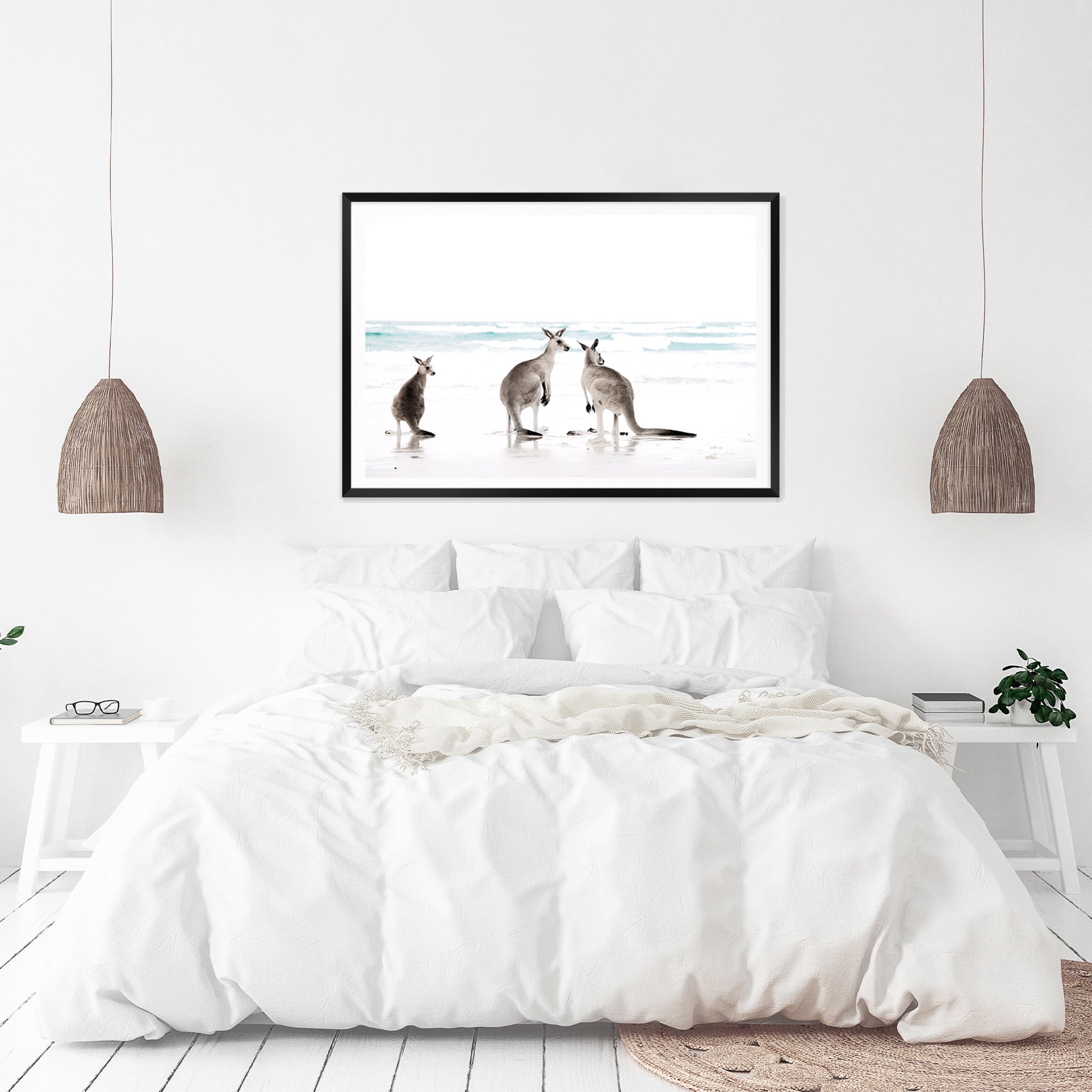 A framed or unframed coastal art print of three kangaroos enjoying some time on the beach, available in natural timber, black or white frames.