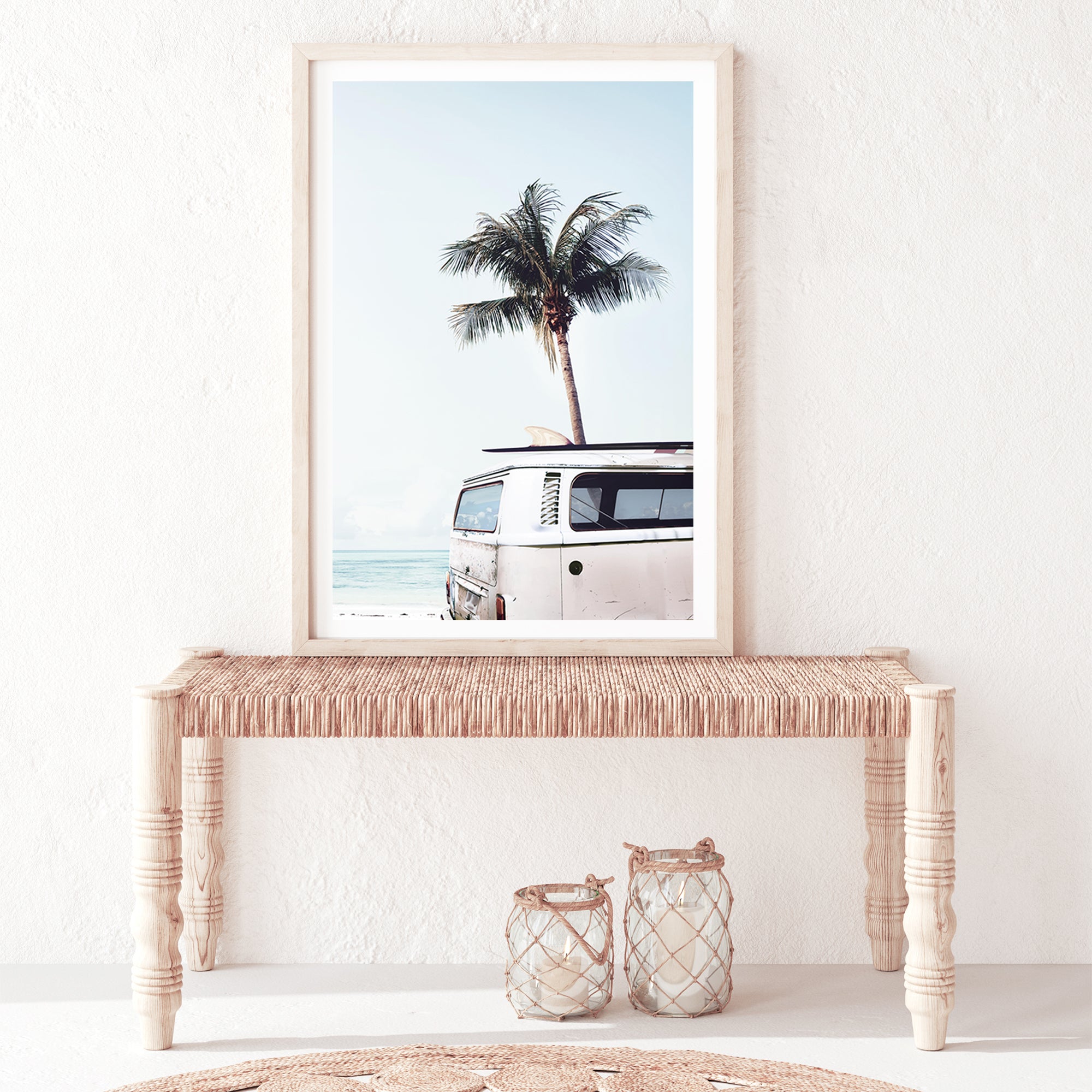 A framed or unframed canvas artwork featuring a blue Kombi van at the beach with a blue sky and palm trees.