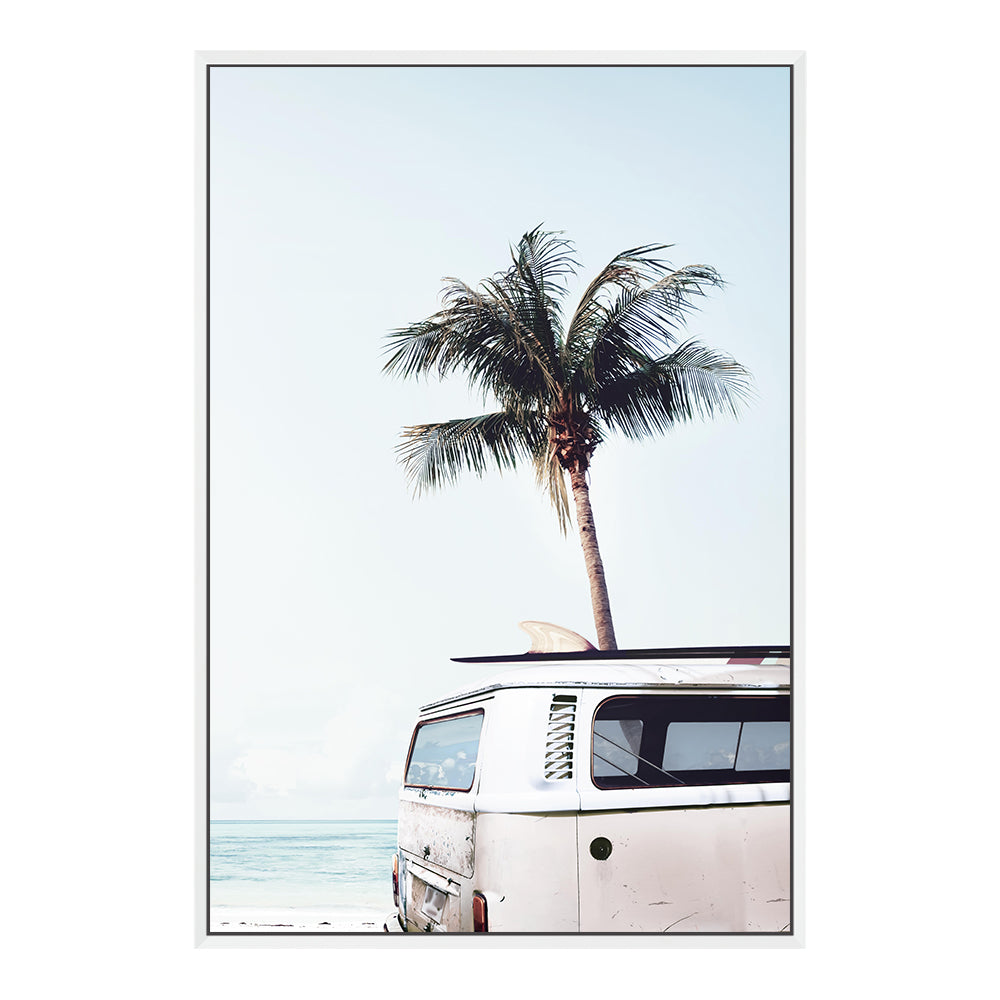 A canvas artwork featuring a blue Kombi van at the beach with a blue sky and palm trees, available in framed or unframed prints.
