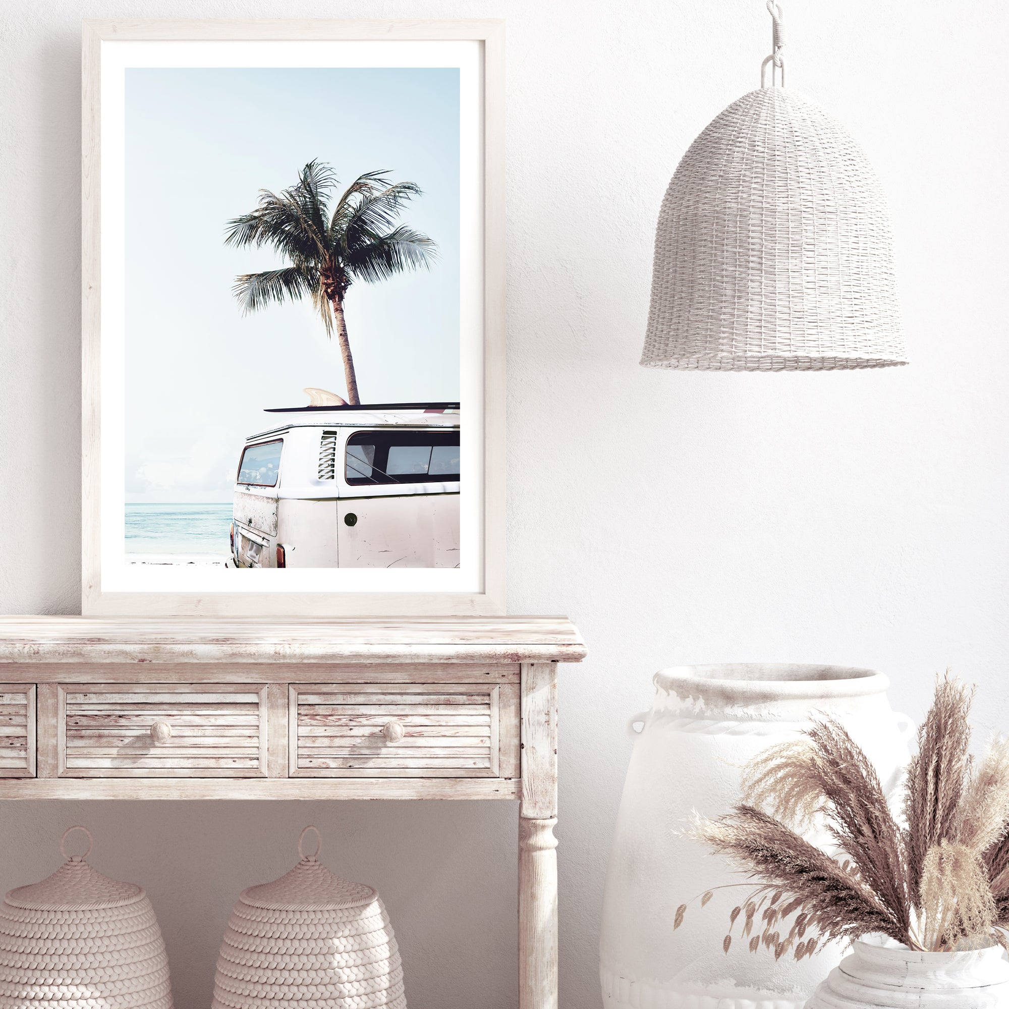 A wall art print featuring a blue Kombi van at the beach with a blue sky and palm trees, in canvas or photo print.