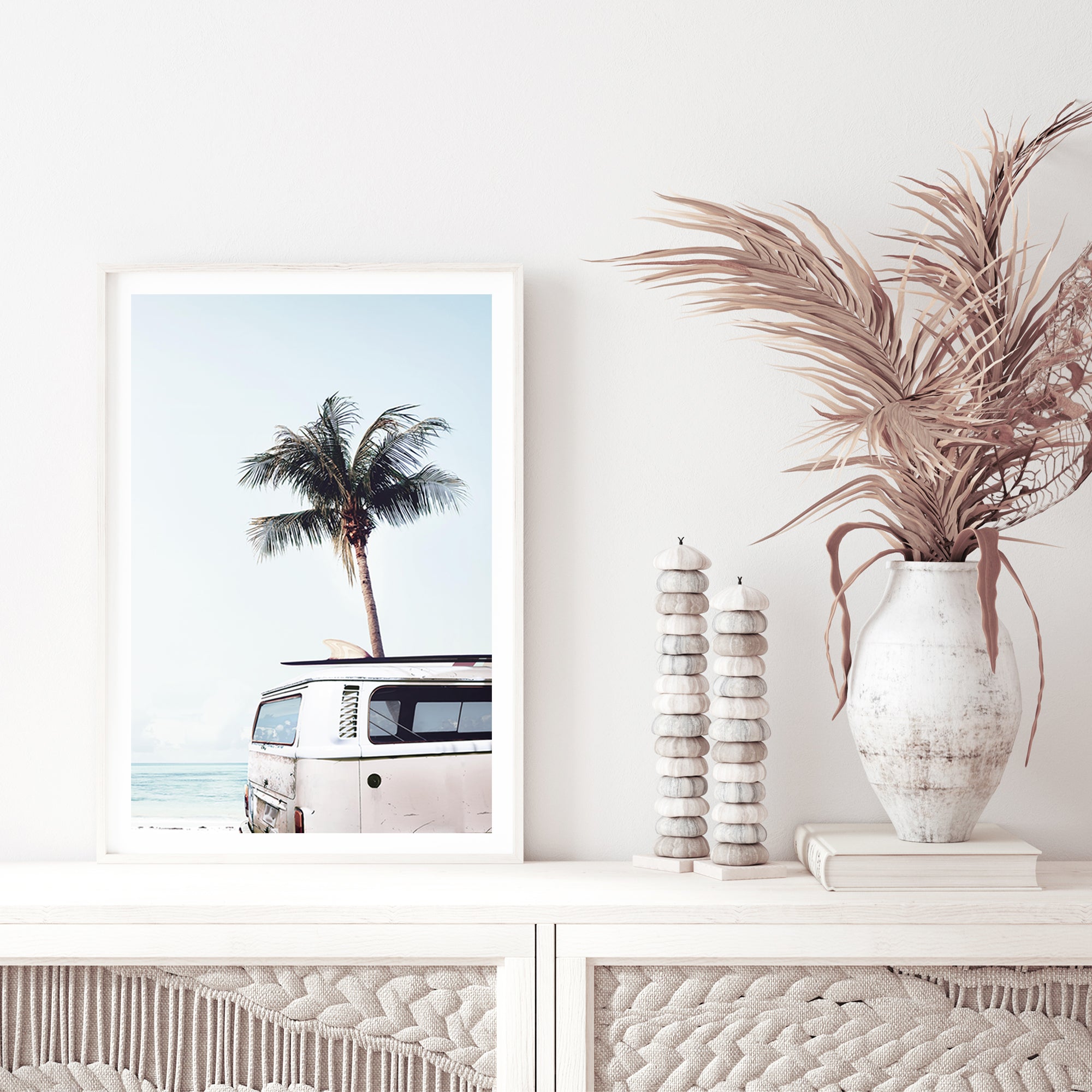 An artwork featuring a blue Kombi van at the beach with a blue sky and palm trees,  in canvas or photo print.