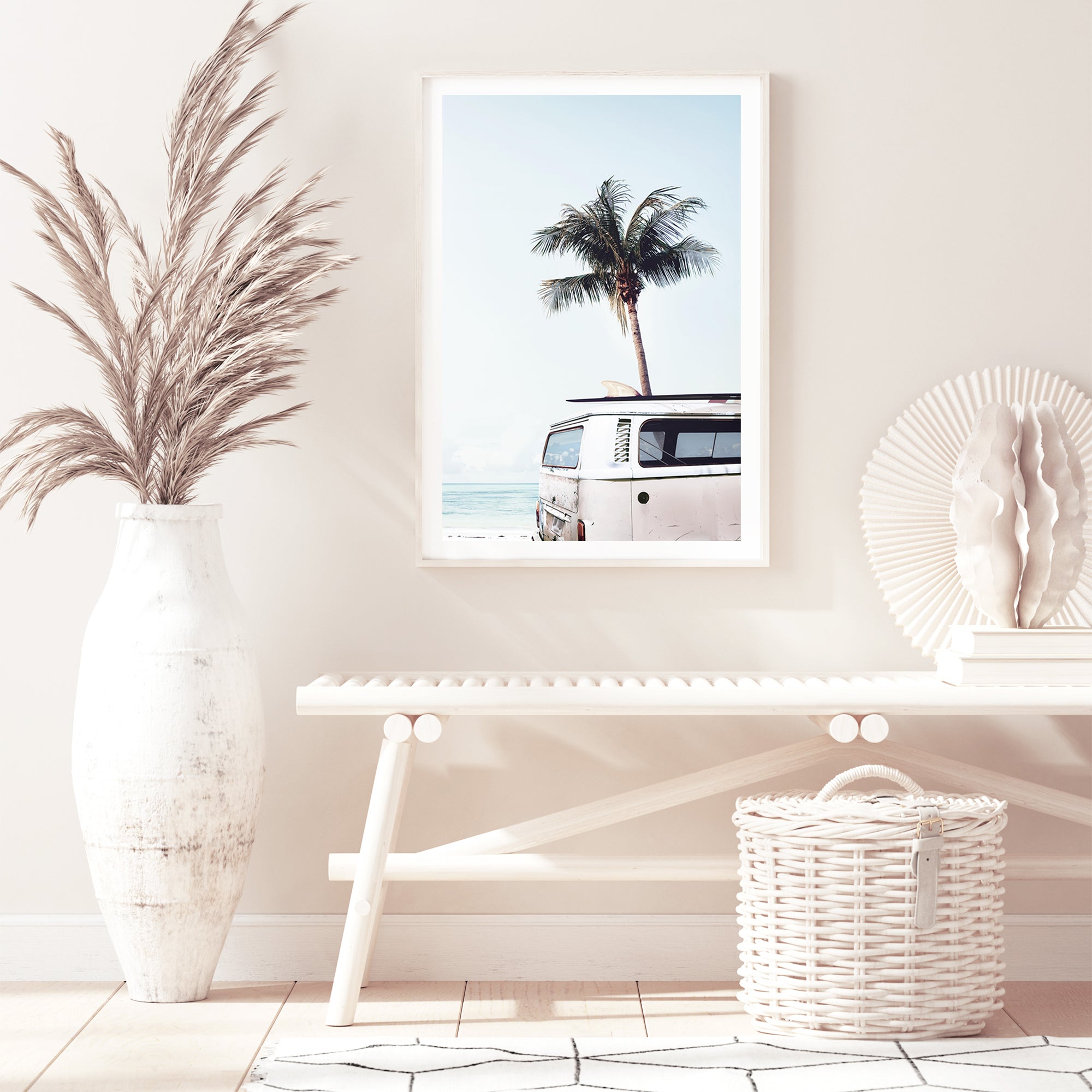 A blue Kombi van at the beach with a blue sky and palm trees available in a canvas or photo wall art print.