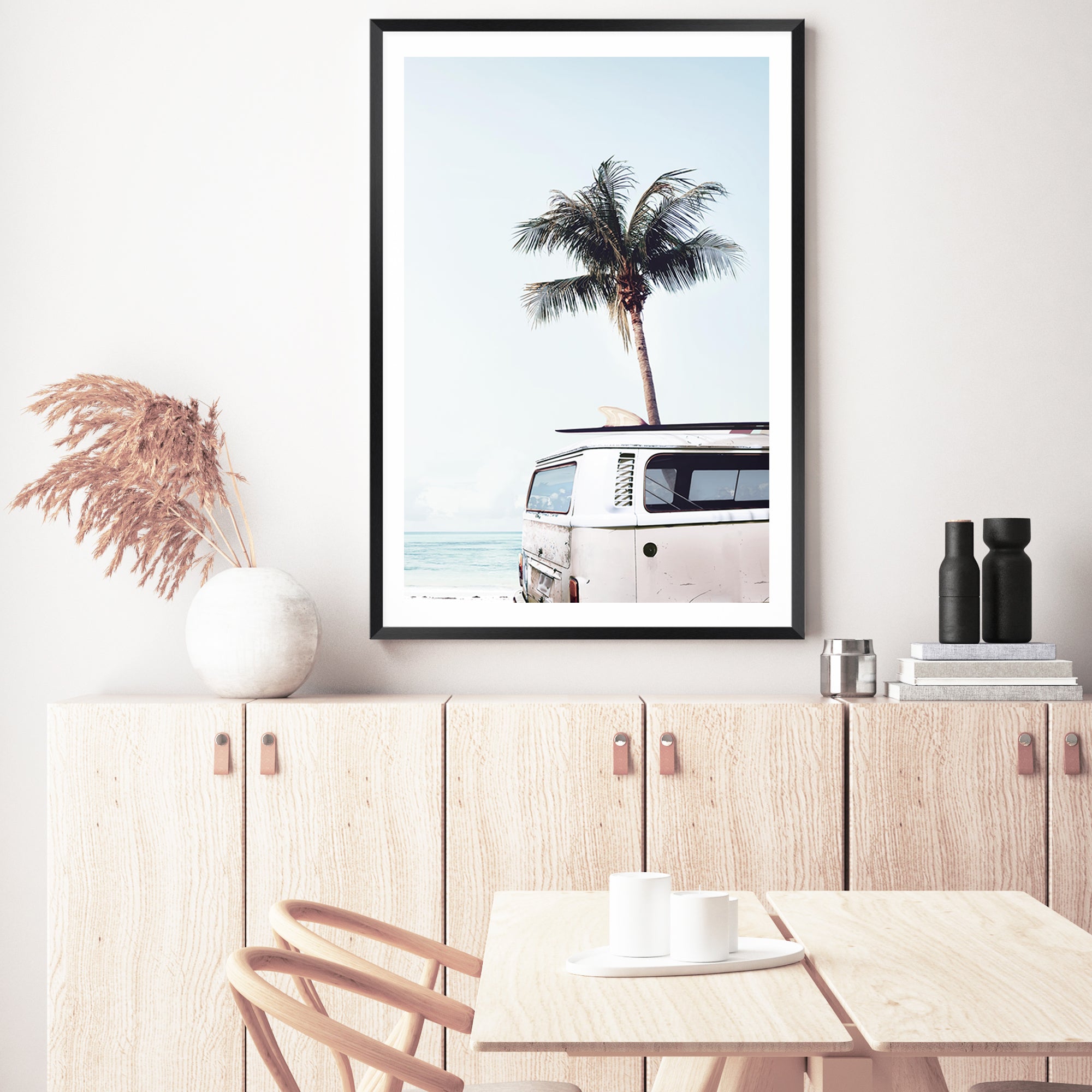 A blue Kombi van at the beach with a blue sky and palm trees available in a photo or canvas artwork.