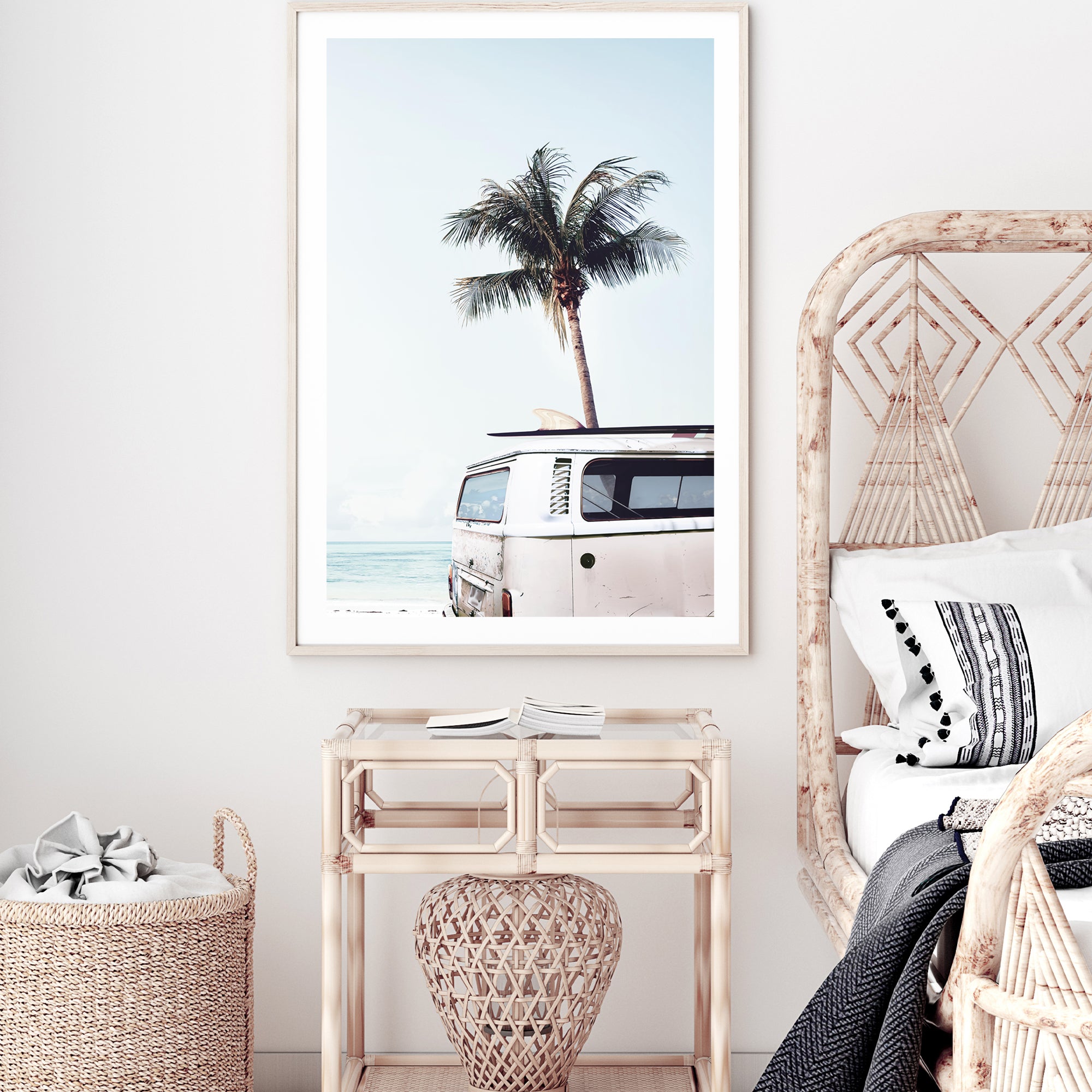 An artwork featuring a blue Kombi van at the beach with a blue sky and palm trees, available in framed or unframed prints.