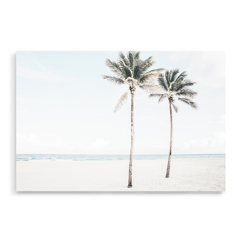 A coastal artwork of  two palm trees and the beach, available framed or unframed.