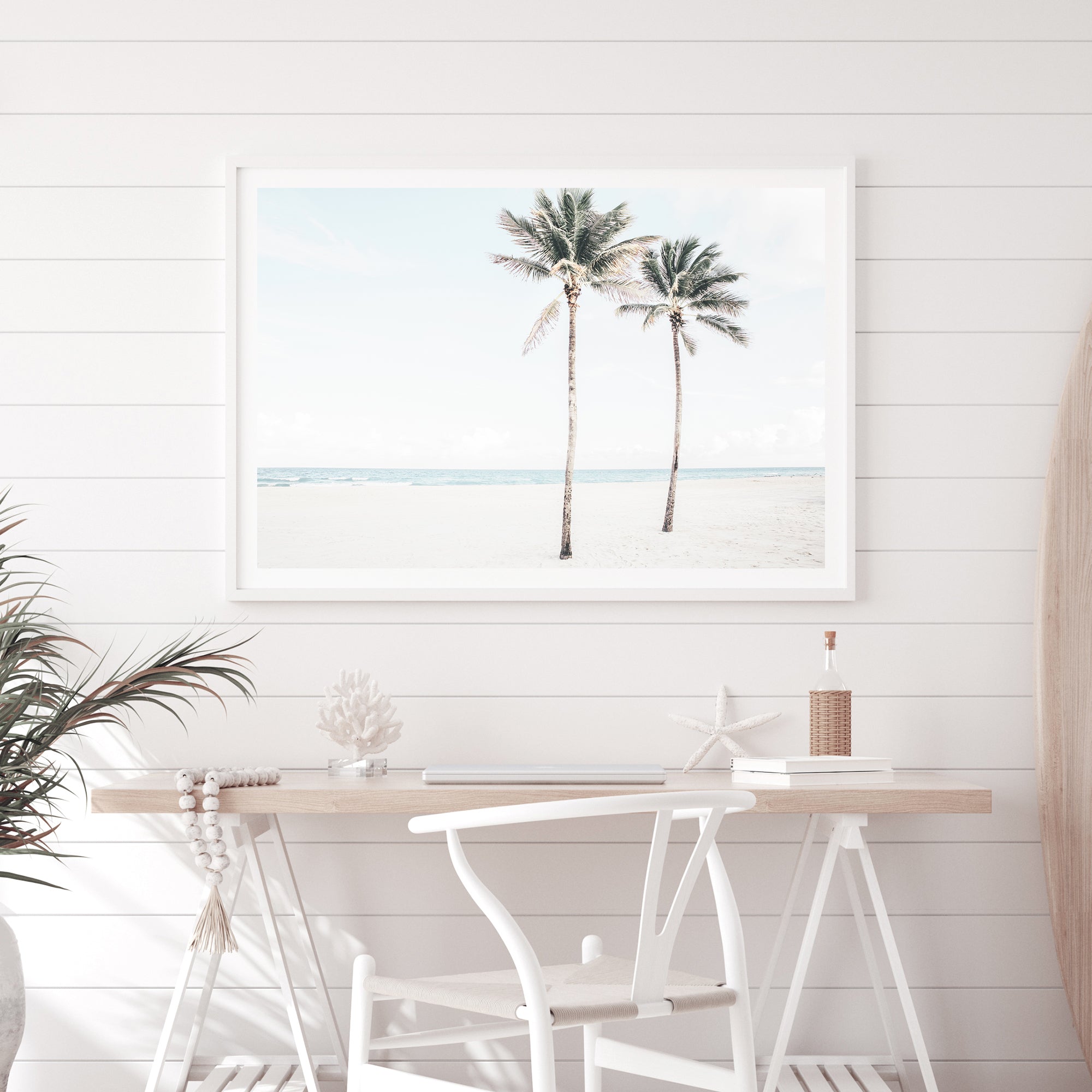 A stretched canvas coastal artwork of two palm trees and the beach, available framed or unframed.