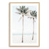 A coastal artwork of blue skies, two palm trees and the beach, available in print and canvas. 