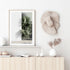 A beautiful framed or unframed wall art print of green palm fronds against a white wall, available in canvas or print. 