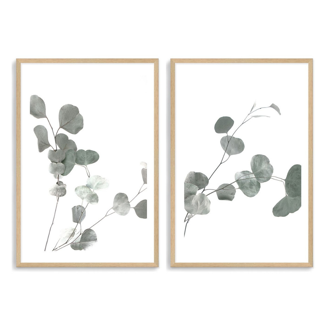 A popular set of 2 wall art prints of eucalyptus leaves with a neutral background, available in an unframed poster print only., pictured here with a frame  