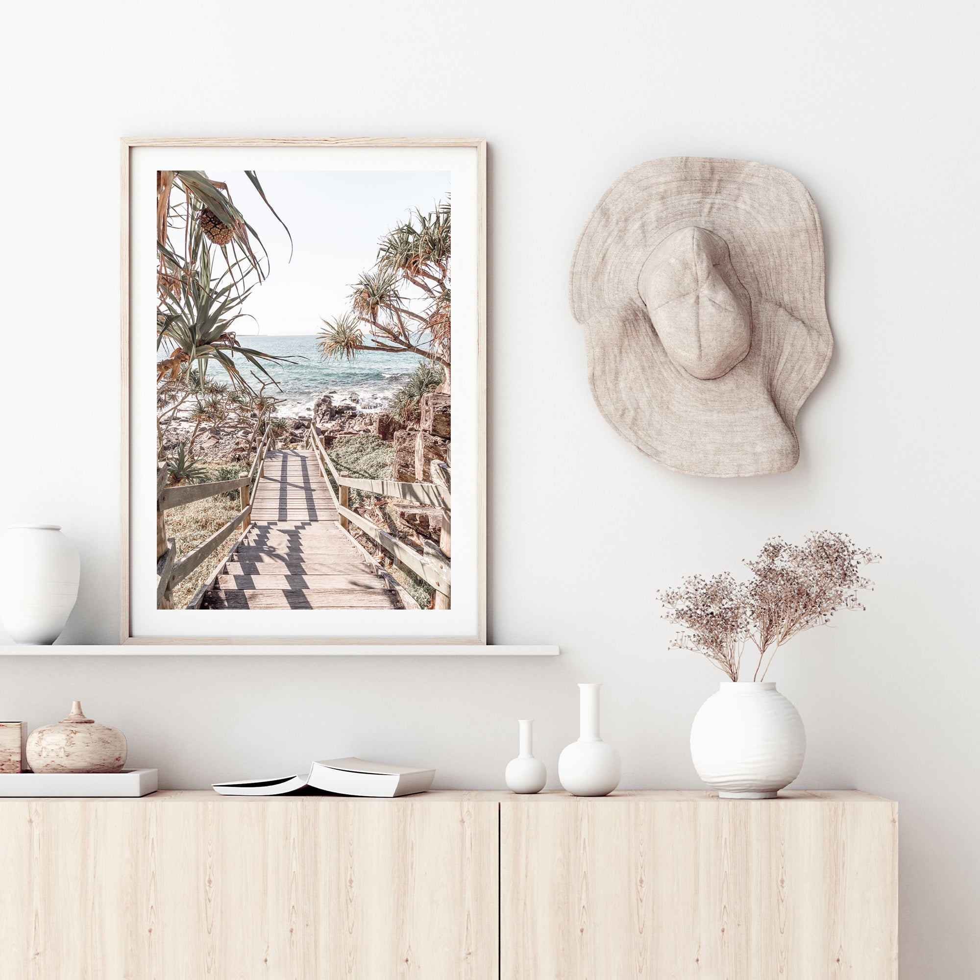 The stunning blue of the sea can be seen from stairs leading onto a Queensland Beach in this photographic wall art print.