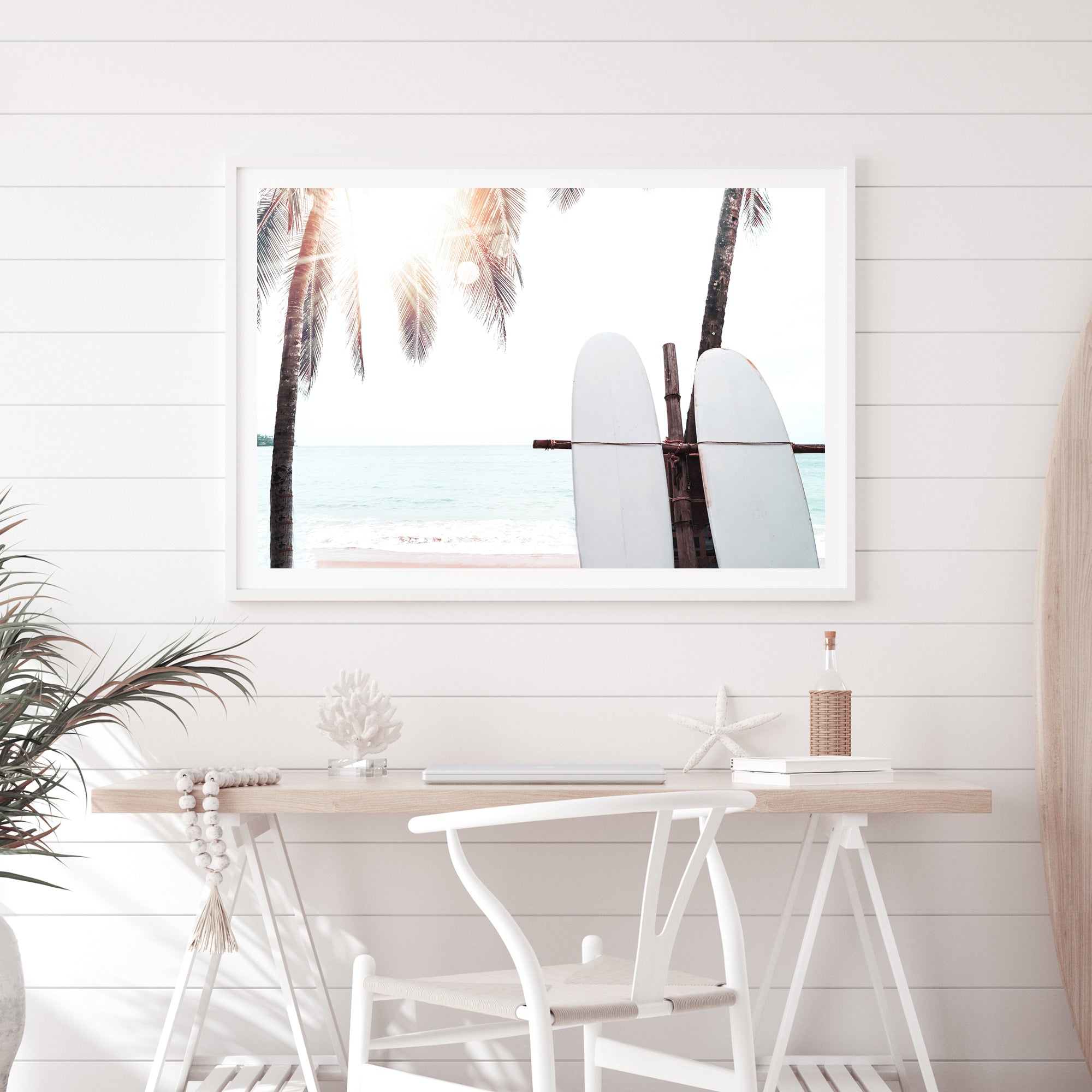 A photo artwork of two white surf boards under the palm trees with a tropical sunset available in canvas and art print.