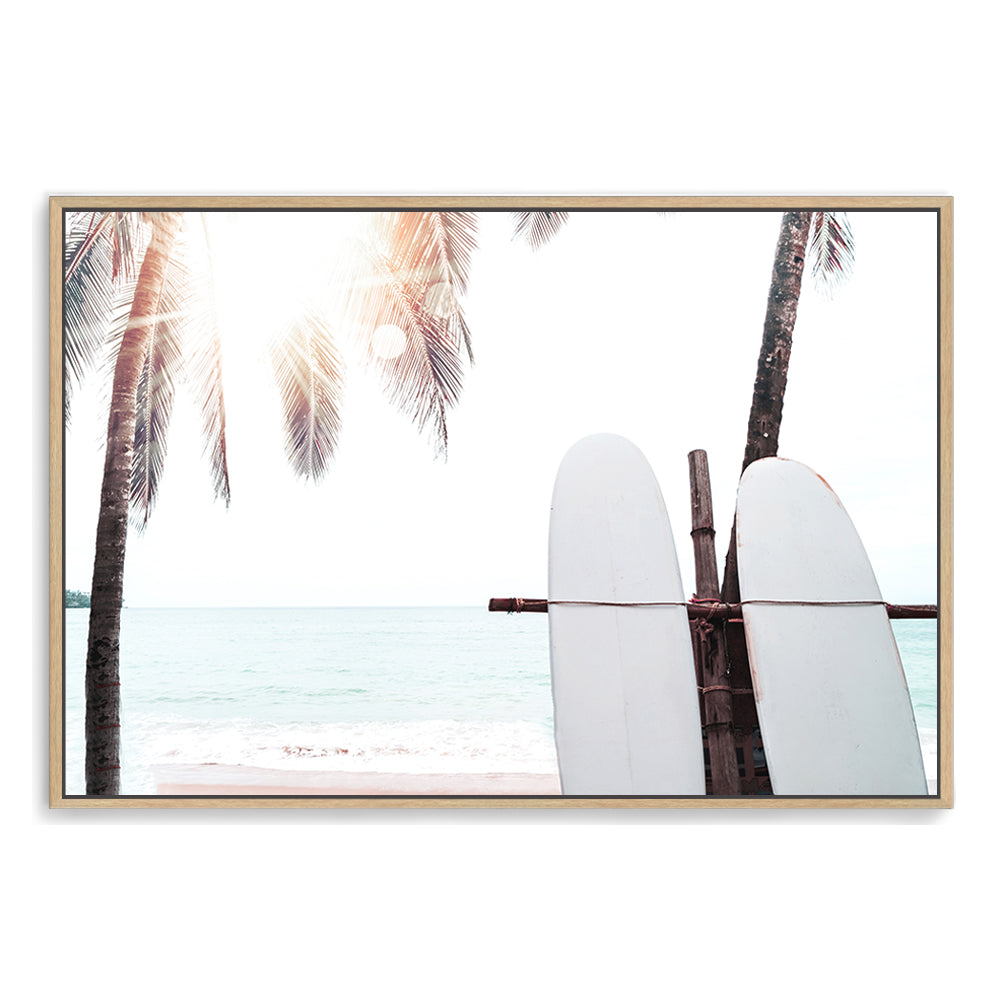 An artwork featuring two white surf boards under the palm trees on a tropical beach available in canvas or print art.