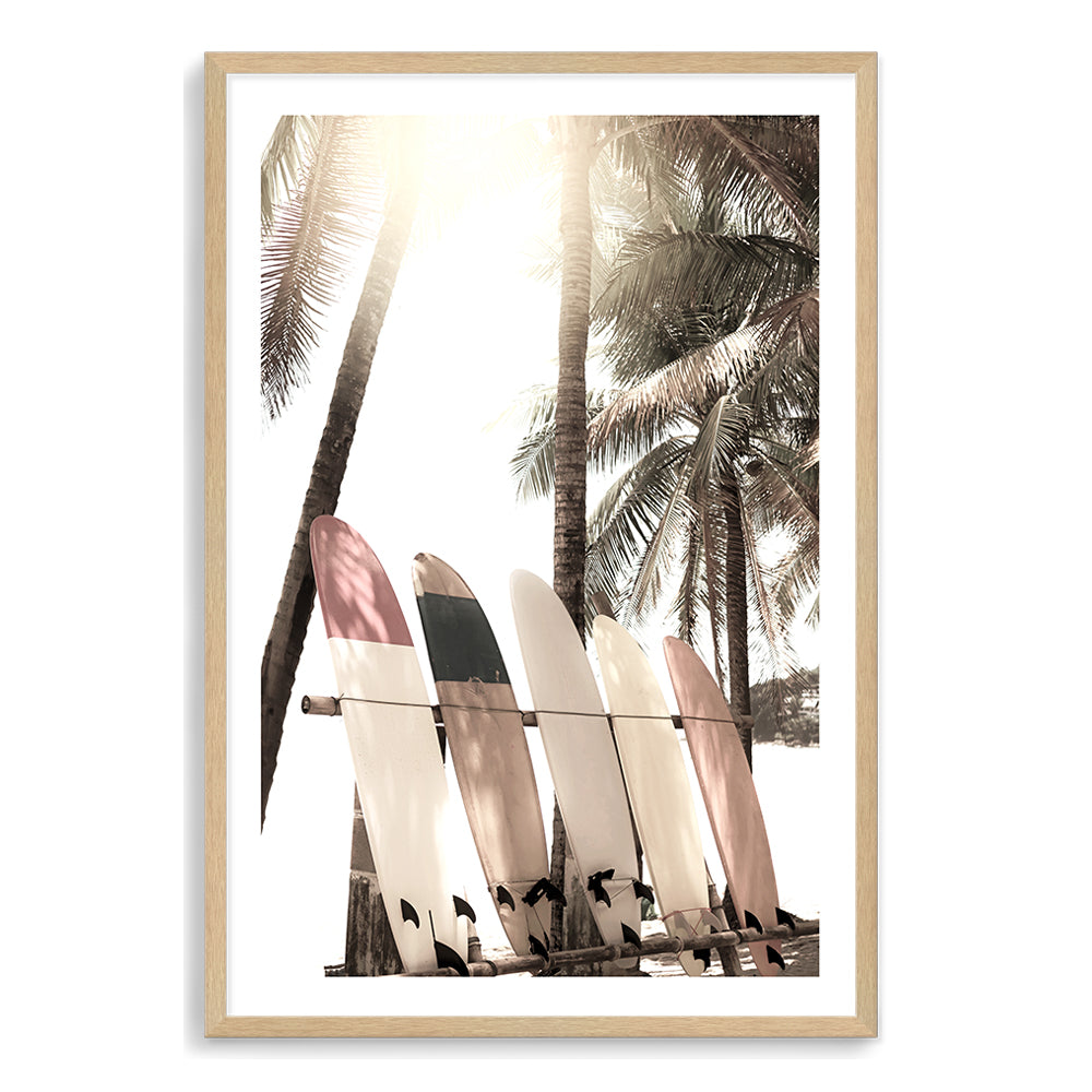 An artwork of four white surf boards under the palm trees with a tropical sunset available in canvas and art print.