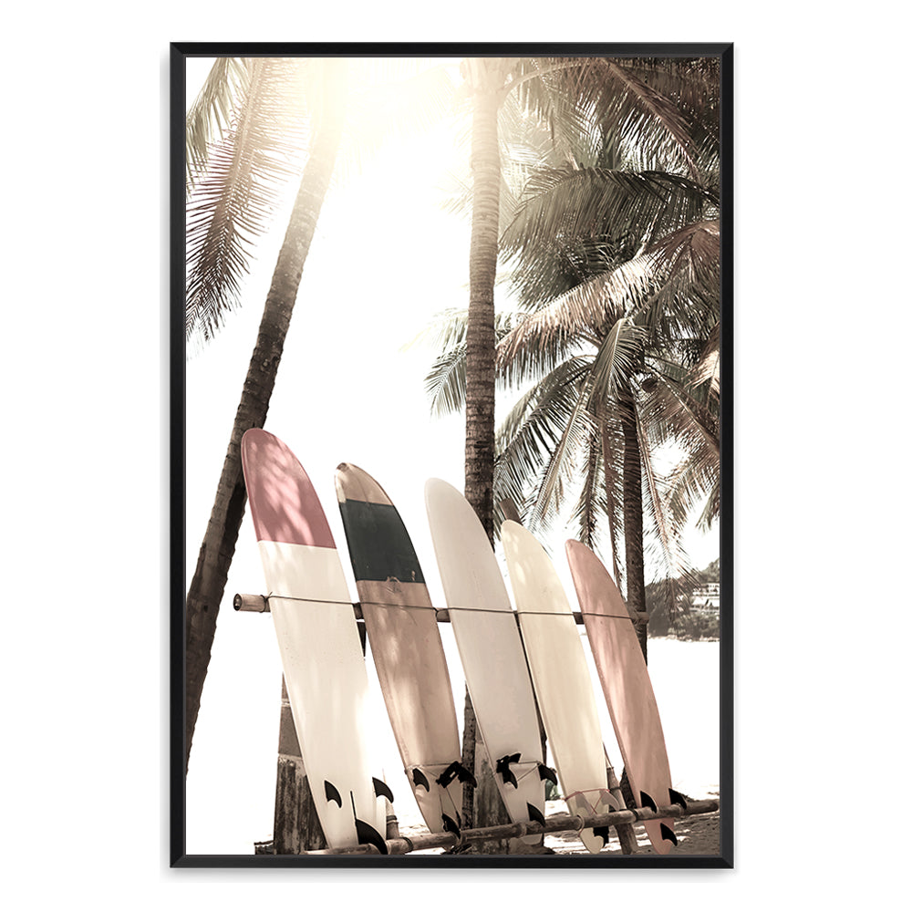A stretched canvas artwork of four white surf boards under the palm trees on a tropical beach, framed or unframed.